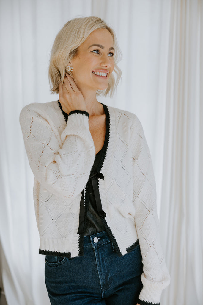 Knit Sweater With Black Trim And Velvet Bow