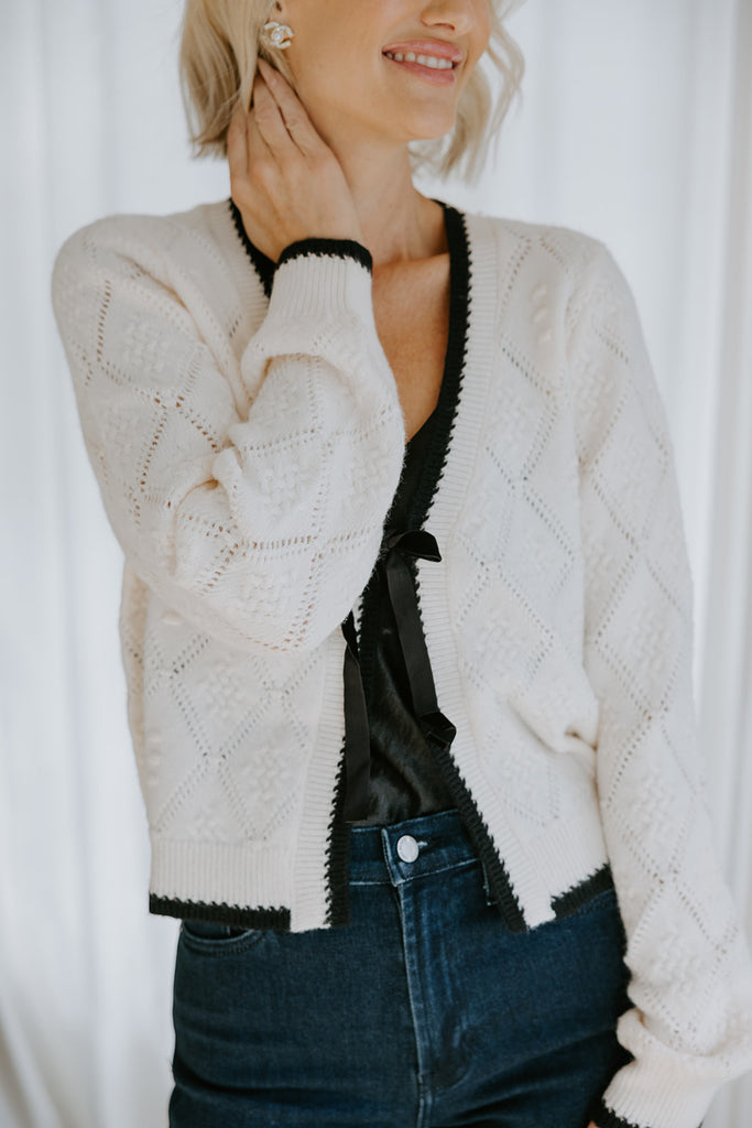 Knit Sweater With Black Trim And Velvet Bow