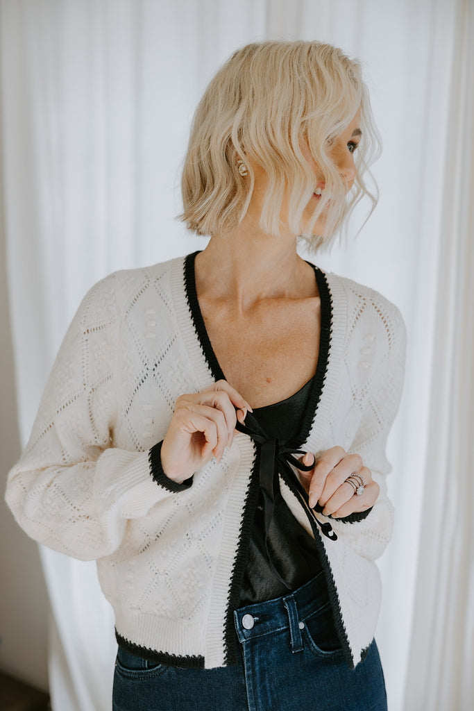 Knit Sweater With Black Trim And Velvet Bow