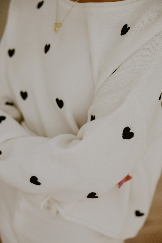 White Sweater with Black Hearts