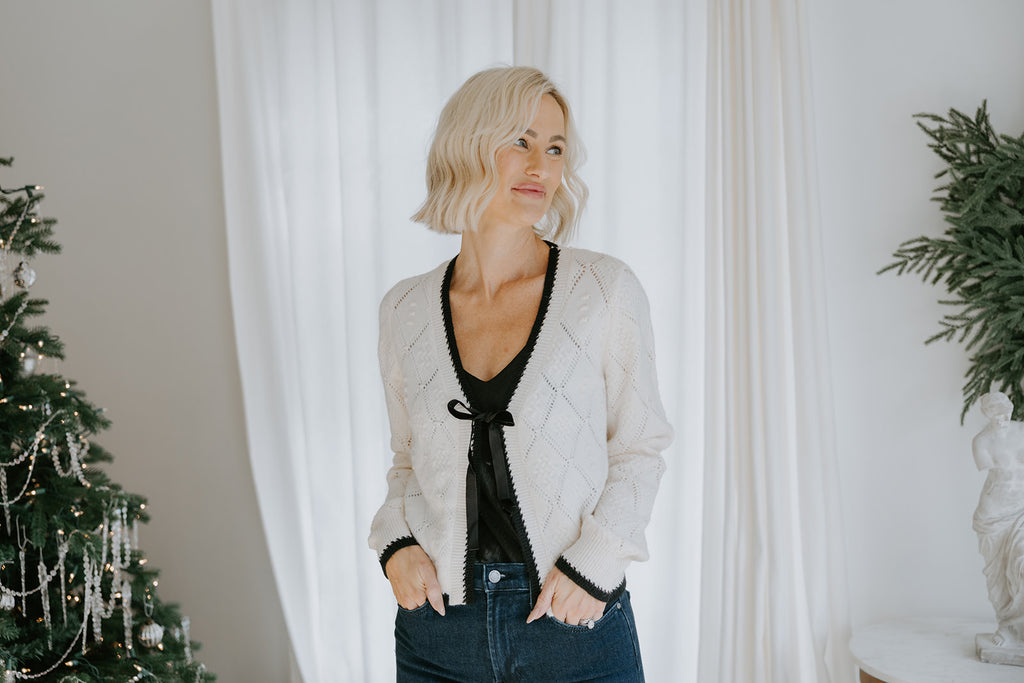 Knit Sweater With Black Trim And Velvet Bow